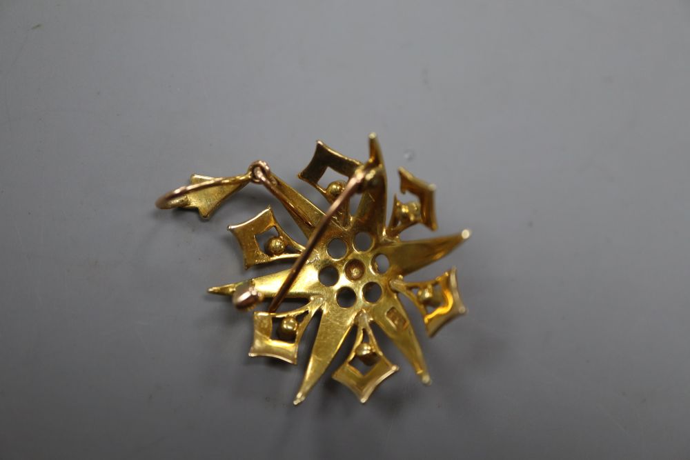 An Edwardian 15ct and graduated seed pearl set starburst pendant brooch, 32mm, gross 6.4 grams.